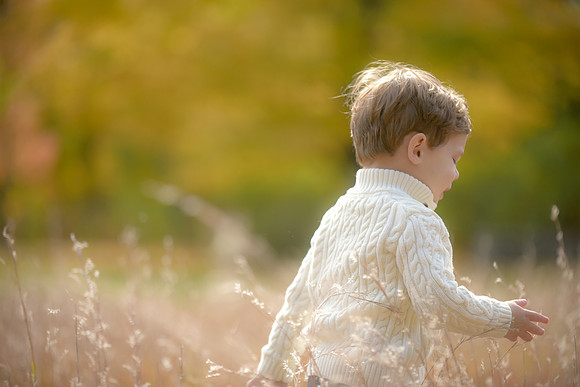 toddler running in field in lexington, ma